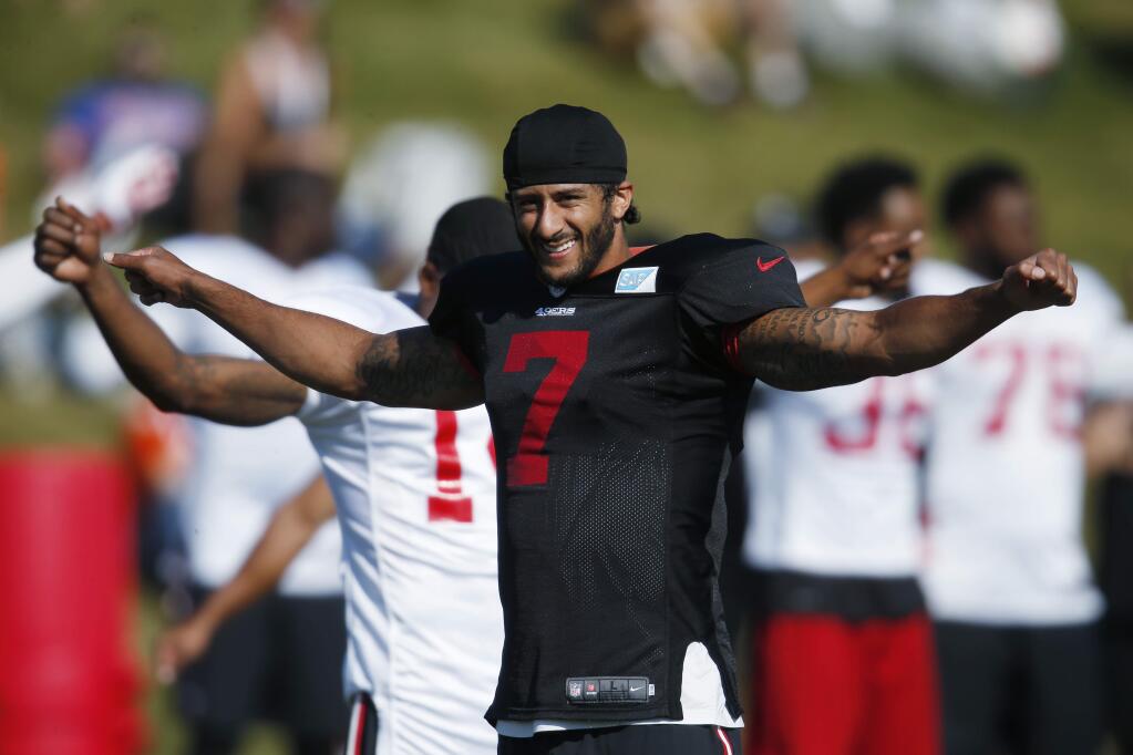 San Francisco 49ers quarterback Colin Kaepernick stretches as players prepare to take part in drills against the Denver Broncos during the teams' joint NFL football training camp session Thursday, Aug. 18, 2016, in Englewood, Colo. (AP Photo/David Zalubowski)