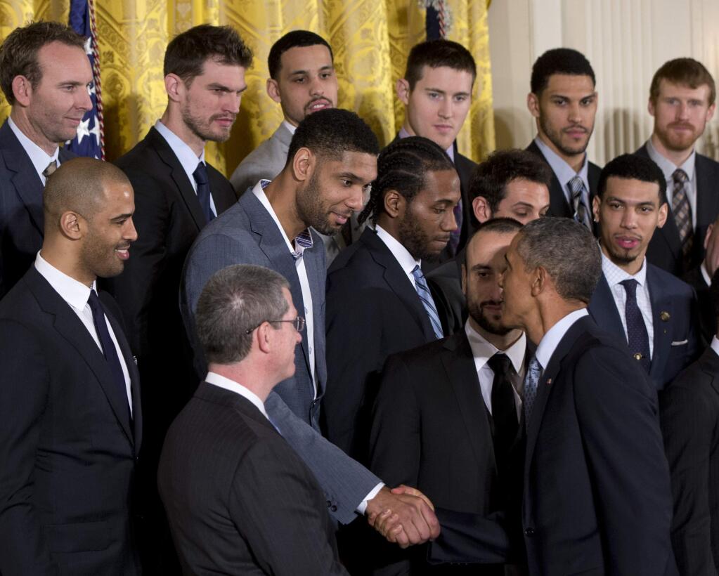 FILE - In this Jan. 12, 2015, file photo, President Barack Obama shakes hands with San Antonio Spurs' forward Tim Duncan, of the Virgin Islands, as he honors the 2014 NBA Champion San Antonio Spurs basketball team during a ceremony in the East Room of the White House in Washington. Duncan announced his retirement on Monday, July 11, 2016, after 19 seasons, five championships, two MVP awards and 15 All-Star appearances. It marks the end of an era for the Spurs and the NBA. (AP Photo/Carolyn Kaster, File)