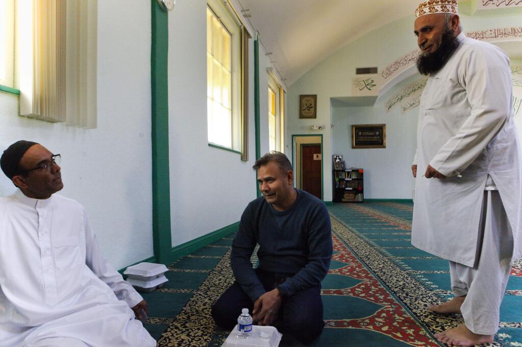 Petaluma, CA, USA. Monday, March 20, 2017._ (left to right) Waseem Khan, Rashid Mughal and Imam Ahmad Ali greet each other after Friday prayers at the Islamic Center of Petaluma. (CRISSY PASCUAL/ARGUS-COURIER STAFF)