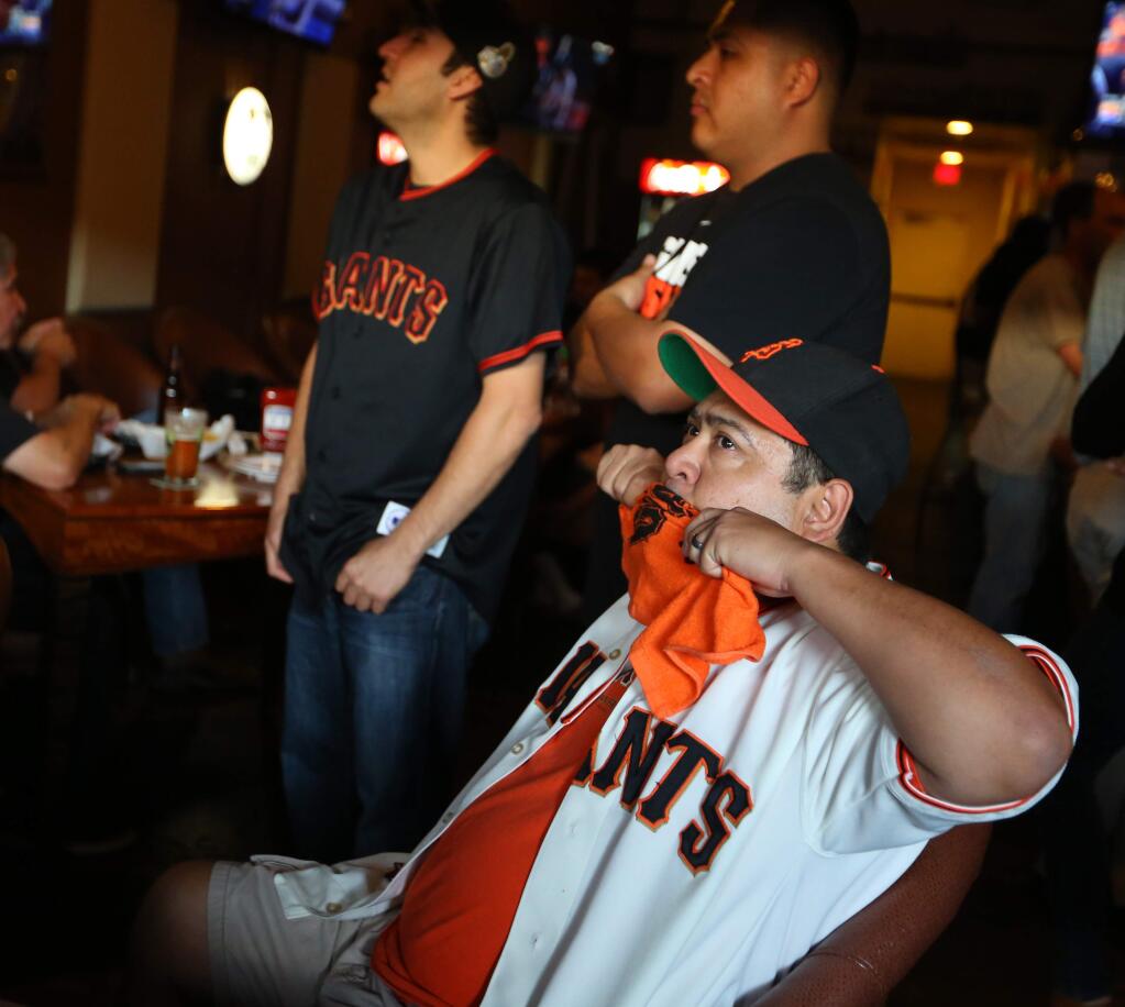 Ruben Lopez reacts while watching the final game of the World Series at Sprenger's Tap Room in Santa Rosa, Wednesday, October 29, 2014. (Crista Jeremiason / The Press Democrat)