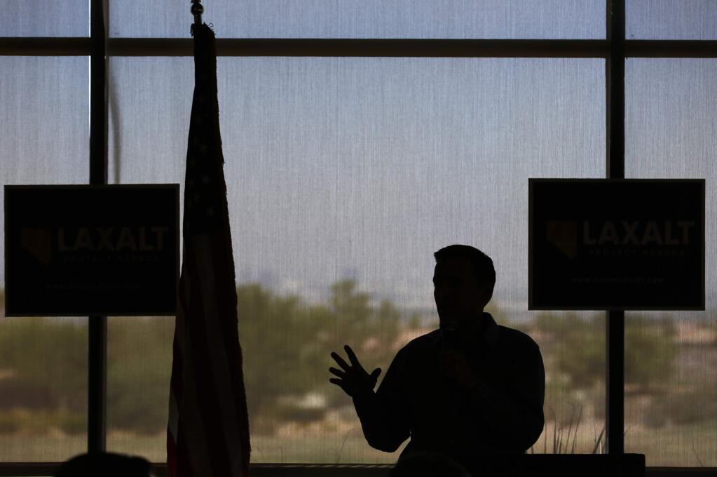 In this Aug. 28, 2018, photo Nevada state Attorney General Adam Laxalt speaks at a campaign event in Henderson, Nev. In the Nevada Governor's race, Laxalt has frequently included anti-California messages in campaign appearances and statements.(AP Photo/John Locher)