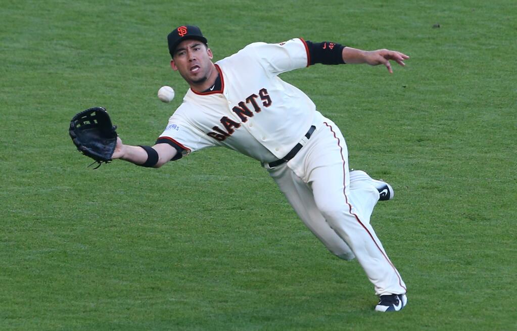 San Francisco Giants left fielder Travis Ishikawa makes a diving catch against the Kansas City Royals, during Game 3 of the World Series in San Francisco on Friday, Oct. 24, 2014. (Christopher Chung / The Press Democrat)