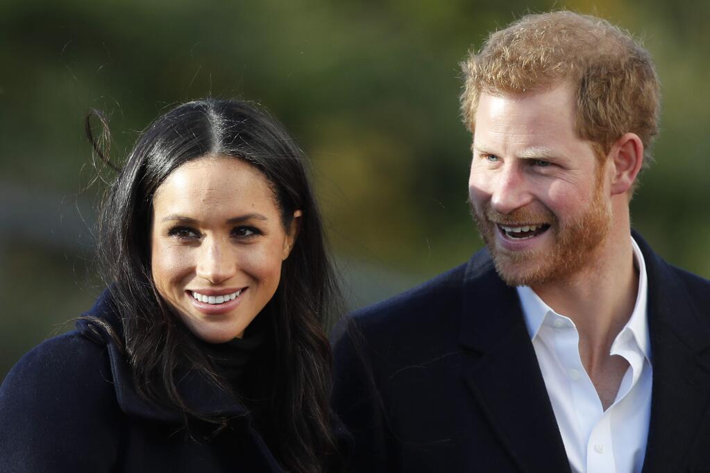 FILE - In this Dec. 1, 2017 file photo, Britain's Prince Harry and his fiancee Meghan Markle arrive at Nottingham Academy in Nottingham, England. It wasn't all doom and gloom in 2017. The year was also filled with awe-inspiring moments that united us and warmed the heart. From a simple proposal over roast chicken to plans for a royal wedding, news that the rugged Prince Harry is engaged to American actress Meghan Markle has many cheering. (AP Photo/Frank Augstein, File)