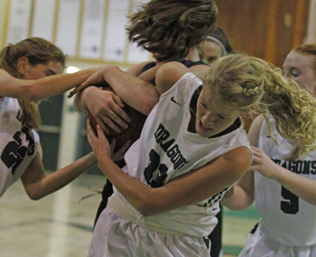 Bill Hoban/Index-TribuneSonoma's Katie Stovall, left, and Grace Cutting, center, try to wrestle a rebound away from a Drake player Friday night.