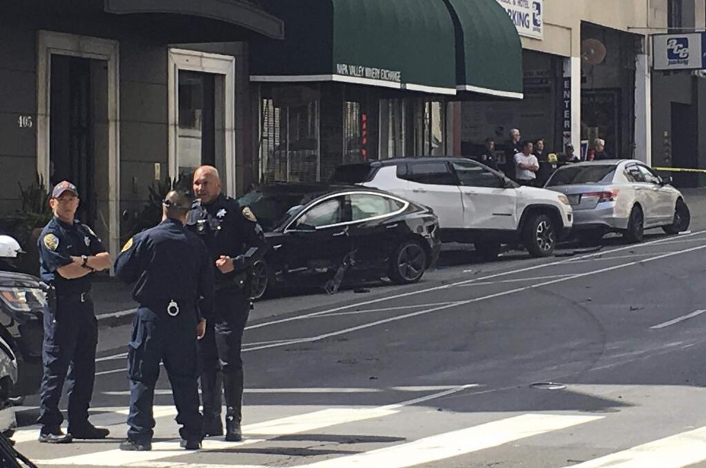 This photo taken Sunday, July 21, 2019, and provided by KGO-TV shows the scene after a woman was arrested after running a red light in a rented Tesla in San Francisco and causing a crash that killed a tourist and left his wife critically injured. Officers were investigating whether the Tesla, which was rented through the peer-to-peer car rental service Get Around, was operating on self-driving mode, police said in a statement Monday, July 22, 2019. (Kate Larsen/KGO-TV via AP)