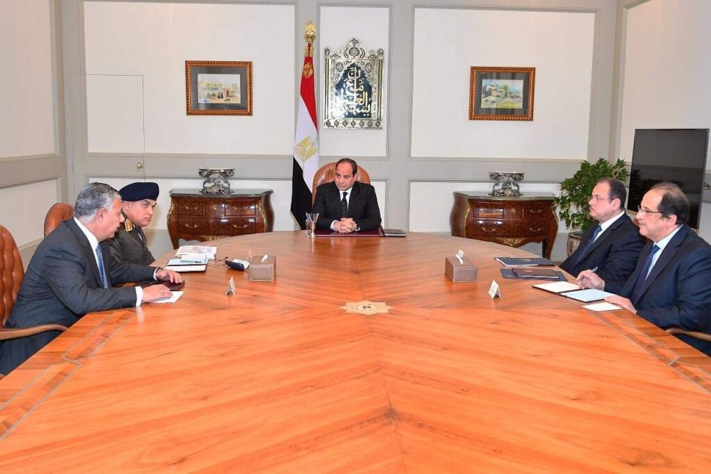 This photo released by Egypt's Presidency shows Abdel-Fattah El-Sissi, center, meeting with officials in Cairo after militants attacked a crowded mosque during Friday prayers in the Sinai Peninsula. The attackers set off explosives, spraying worshippers with gunfire and killing at least 184 people in the deadliest ever attack on Egyptian civilians by Islamic extremists. (Egyptian Presidency via AP)