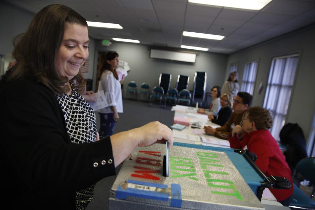 Joanna Pinckney puts her vote in the ballot box at the Community Center in Petaluma, California on Tuesday, March 3, 2020. (BETH SCHLANKER/The Press Democrat)