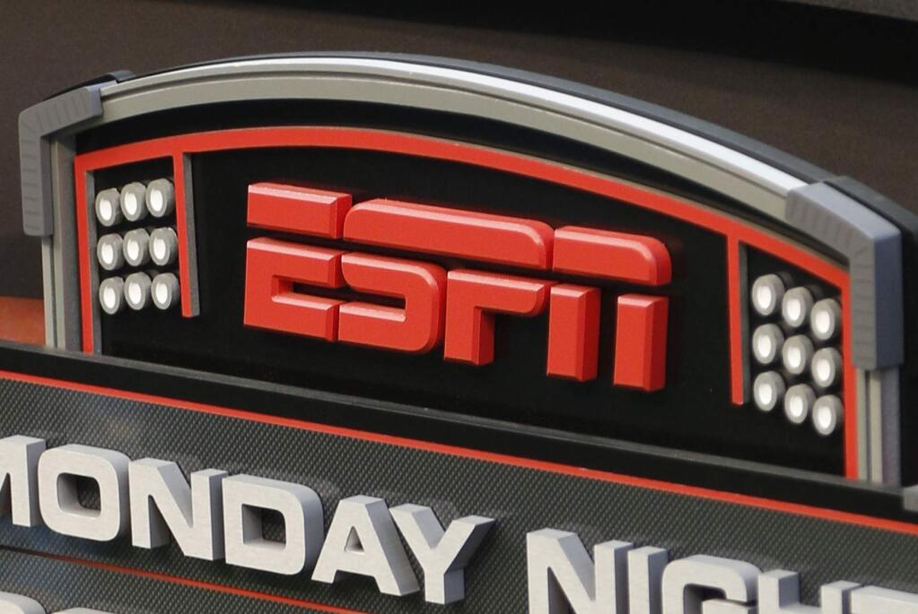 This Sept. 16, 2013, file photo shows the ESPN logo prior to an NFL game between the Cincinnati Bengals and the Pittsburgh Steelers in Cincinnati. A former ESPN personality is accusing the network of trying to silence her and other women who assert they were subjected to a sexually hostile work environment. (AP Photo/David Kohl, File)