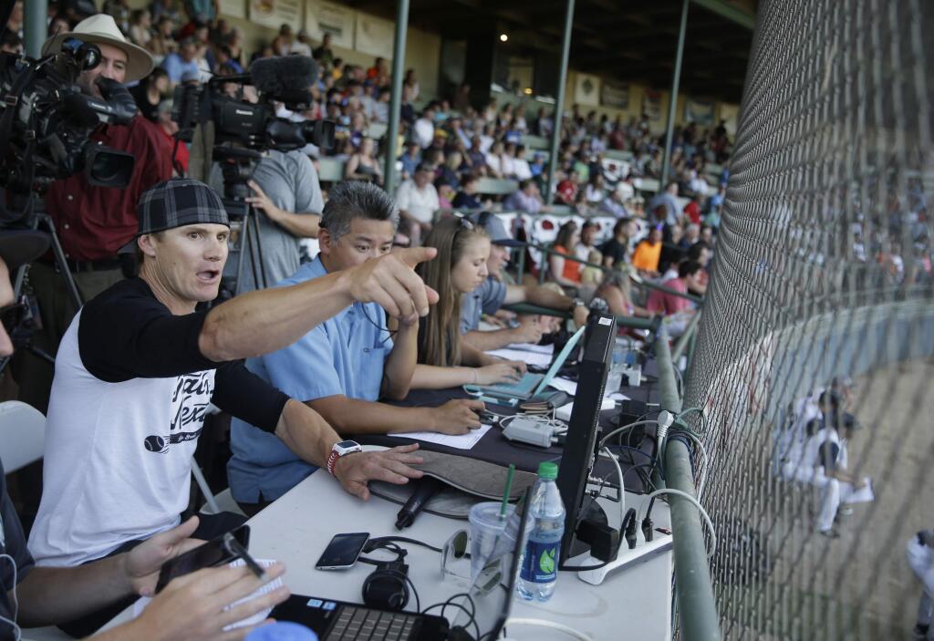 Former major league outfielder Eric Byrnes gestures while using a computerized video system to call balls and strikes at an independent minor league baseball game between the San Rafael Pacifics and Vallejo Admirals Tuesday, July 28, 2015, in San Rafael, Calif. On Tuesday night, the computer system will stood in for pitch calls in what is considered to be the first professional game without the umpire making those decisions. A full umpiring crew will be there for everything else. (AP Photo/Eric Risberg)