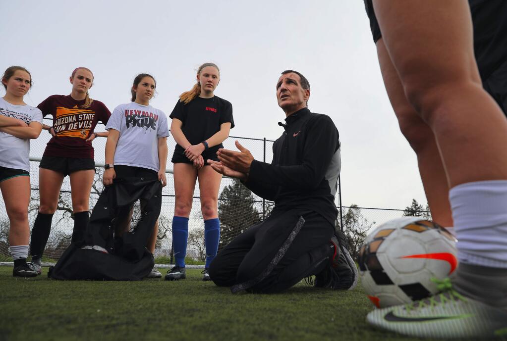 Cardinal Newman girls soccer coach John Gilson talks to his players at the end of practice in Santa Rosa on Friday, March 9, 2018. (Christopher Chung / The Press Democrat)