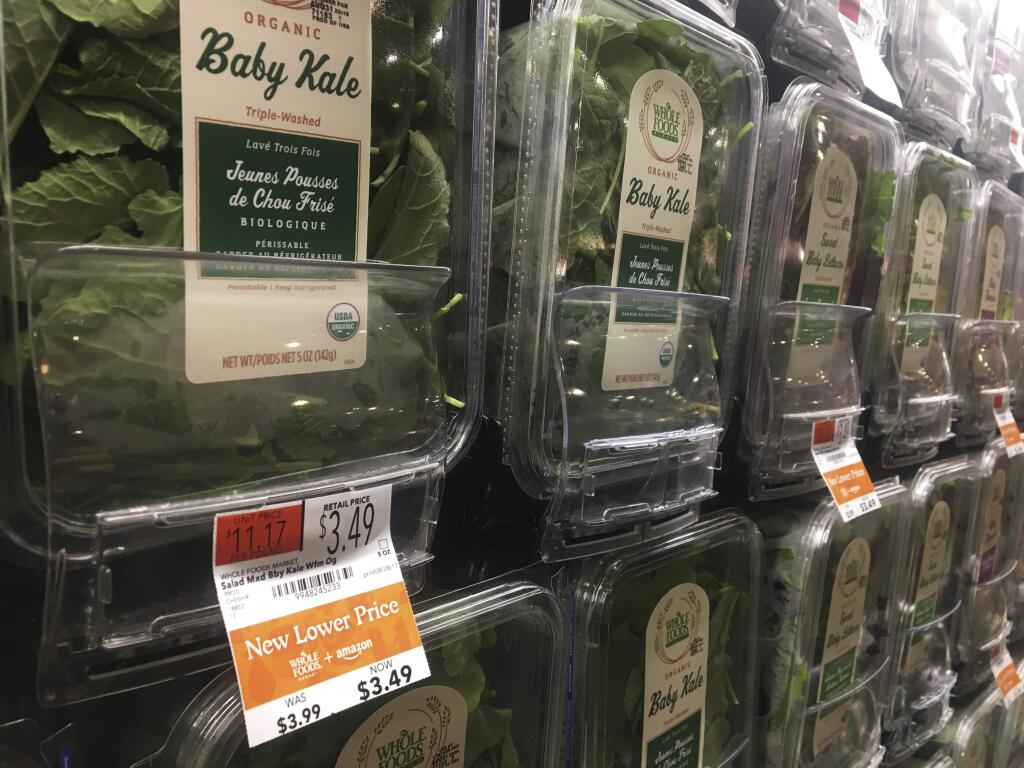 Organic baby kale that has been reduced in price appears on sale at a Whole Foods Market in New York, Monday, Aug. 28, 2017. Amazon has completed its $13.7 billion takeover of organic grocer Whole Foods, and the e-commerce giant is wasting no time putting its stamp on the company. Prices were lowered; Whole Foods brands will soon be on Amazon's site; and Amazon's Prime members could soon get discounts at Whole Foods. The deal could also spur changes in the wider grocery industry. (AP Photo/Joseph Pisani)