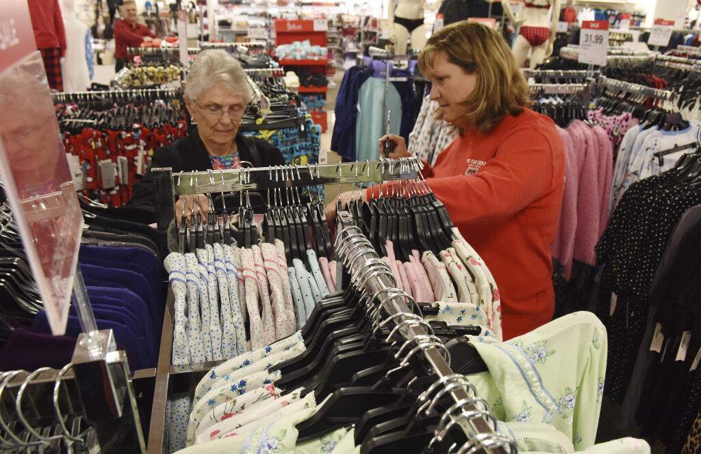 Peggy Ferrell of Tyler and Marla Clements of Flint, shop in the pajama section of JCPenney in Tyler, Texas, Friday, Nov. 18, 2016. JCPenney will open Thanksgiving Day at 3 p.m. for their Black Friday sale. (Sarah A. Miller/Tyler Morning Telegraph via AP)