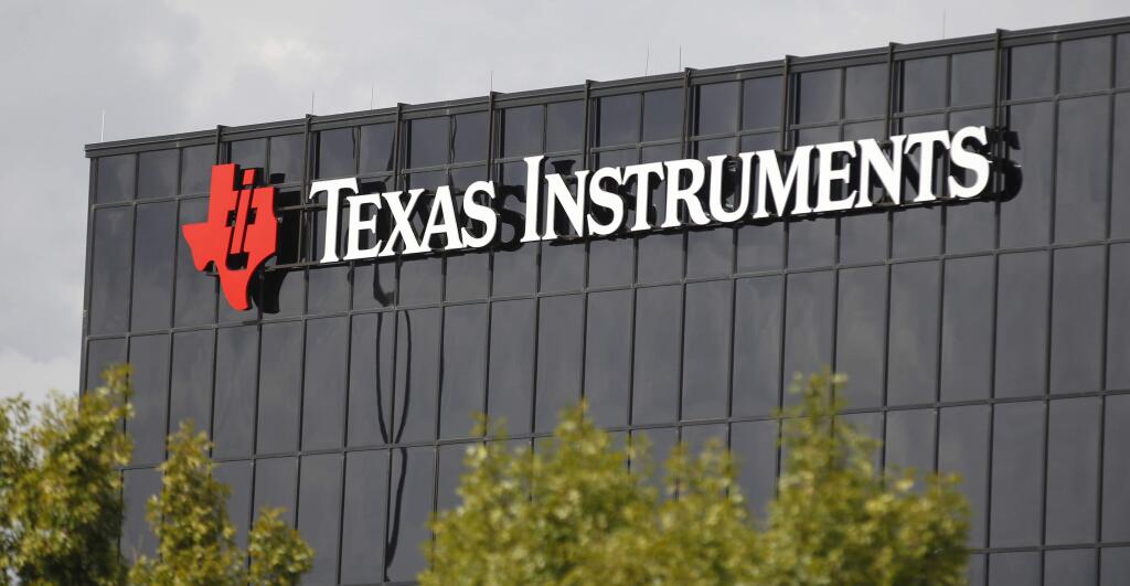 FILE - This Monday, Oct. 22, 2012, file photo shows corporate signage on the offices of Texas Instruments, in Richardson, Texas. On Tuesday, July 17, 2018, Texas Instruments dumped CEO Brian Crutcher for personal misconduct less than two months after he took over the job, ruining the chip maker's hopes for a smooth transition to new leadership. (AP Photo/LM Otero, File)