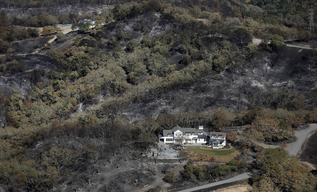 Creating a defensible space around your home can help protect it from wildfire. This home above Windsor survived The Kincade Fire because the homeowners took protective measures . (Kent Porter / The Press Democrat)