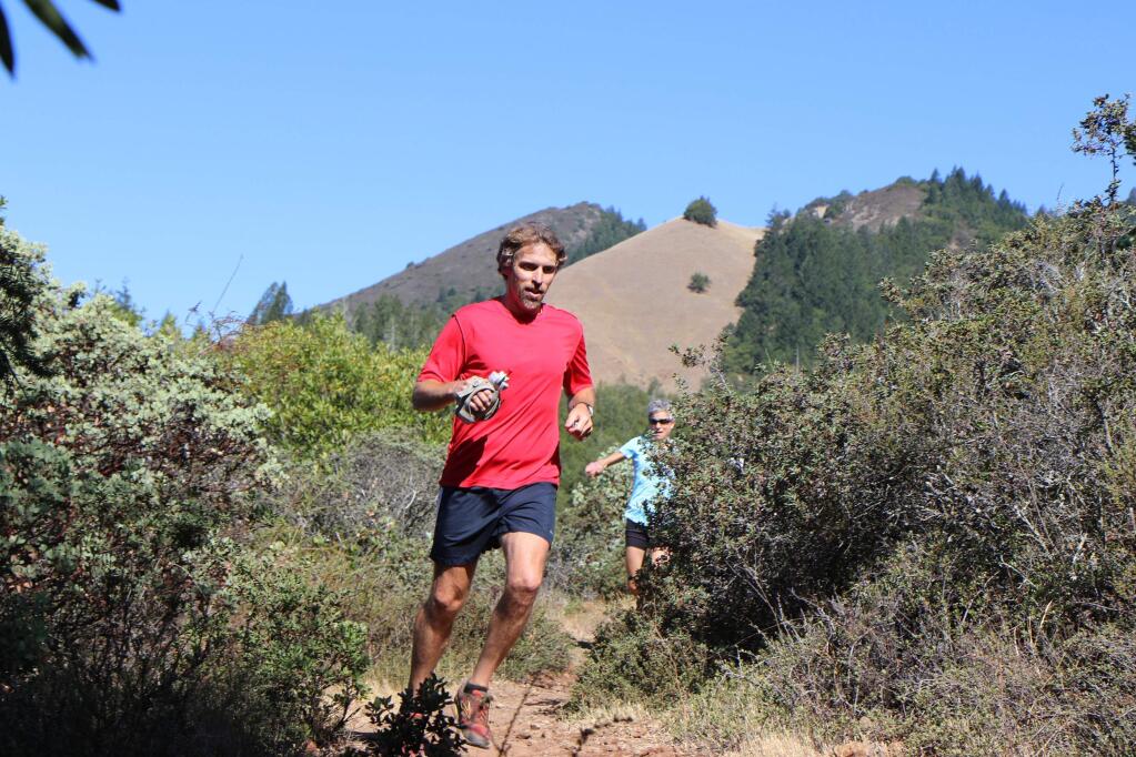RACE DIRECTOR Brian Wyatt explores the trails of Sugarloaf State Park for the up-coming Sonoma Trail Marathon, Oct. 3, 2015. Sonoma's Suzanna Bon is coming up behind him on the trail.(Lessa Manotti/Scena Performance)
