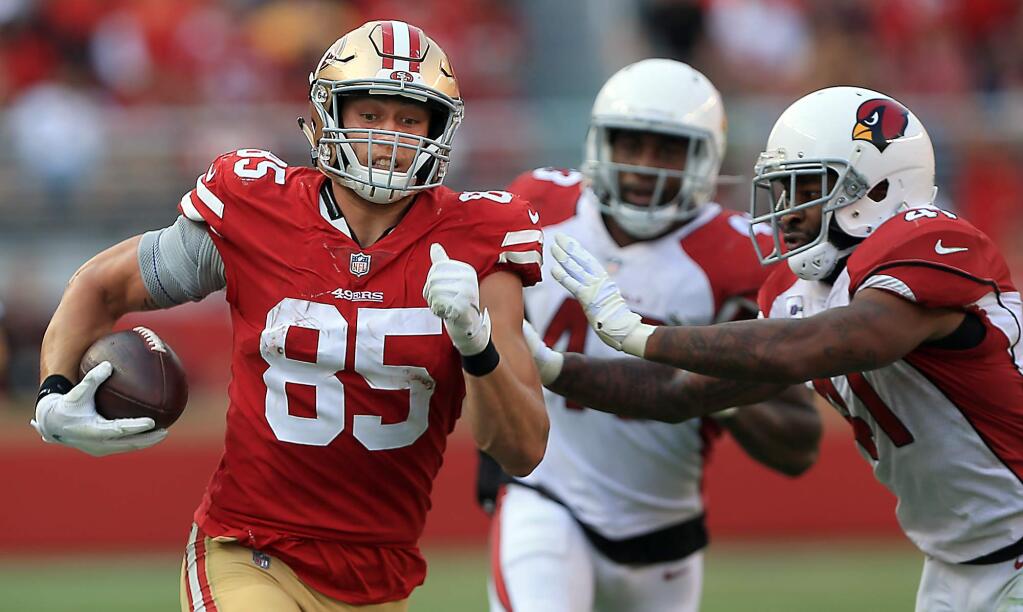 The 49ers' George Kittle rumbles for a first down during the a loss to the Cardinals in Santa Clara on Sunday Oct. 7, 2018. (Kent Porter / The Press Democrat)