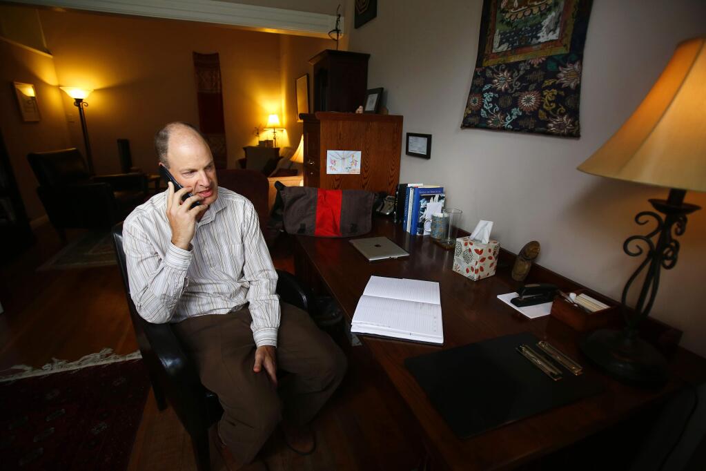 Former Kaiser psychotherapist Andy Weisskoff speaks with a patient by phone at his office in Sebastopol on Tuesday, June 10, 2014. (CONNER JAY/ PD)