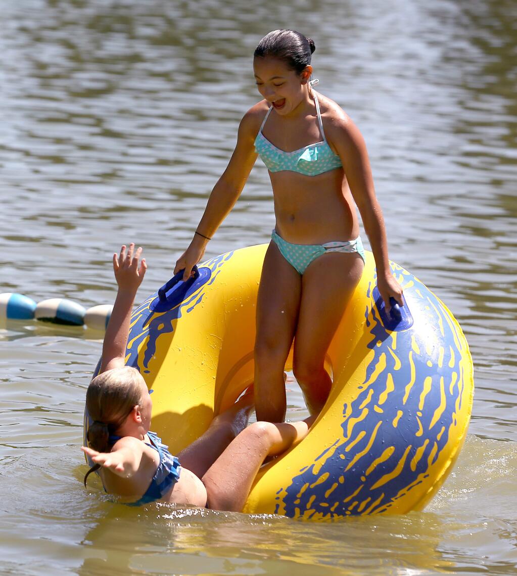 Lexi Neese, 11, left and Taylor Evets, 11, right, play in the water at the Spring Lake Regional Park Swimming Lagoon in Santa Rosa, Wednesday, July 29, 2015. (CRISTA JEREMIASON / The Press Democrat)