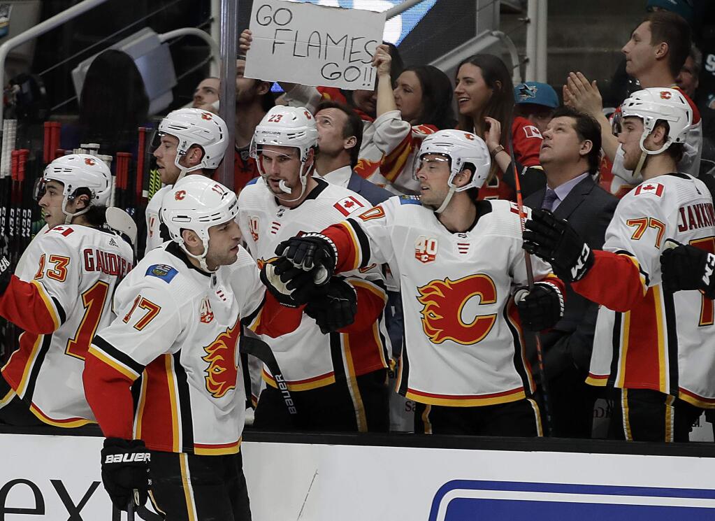 Calgary Flames' Milan Lucic (17) is congratulated after scoring a goal against the San Jose Sharks in the first period of an NHL hockey game Monday, Feb. 10, 2020, in San Jose, Calif. (AP Photo/Ben Margot)