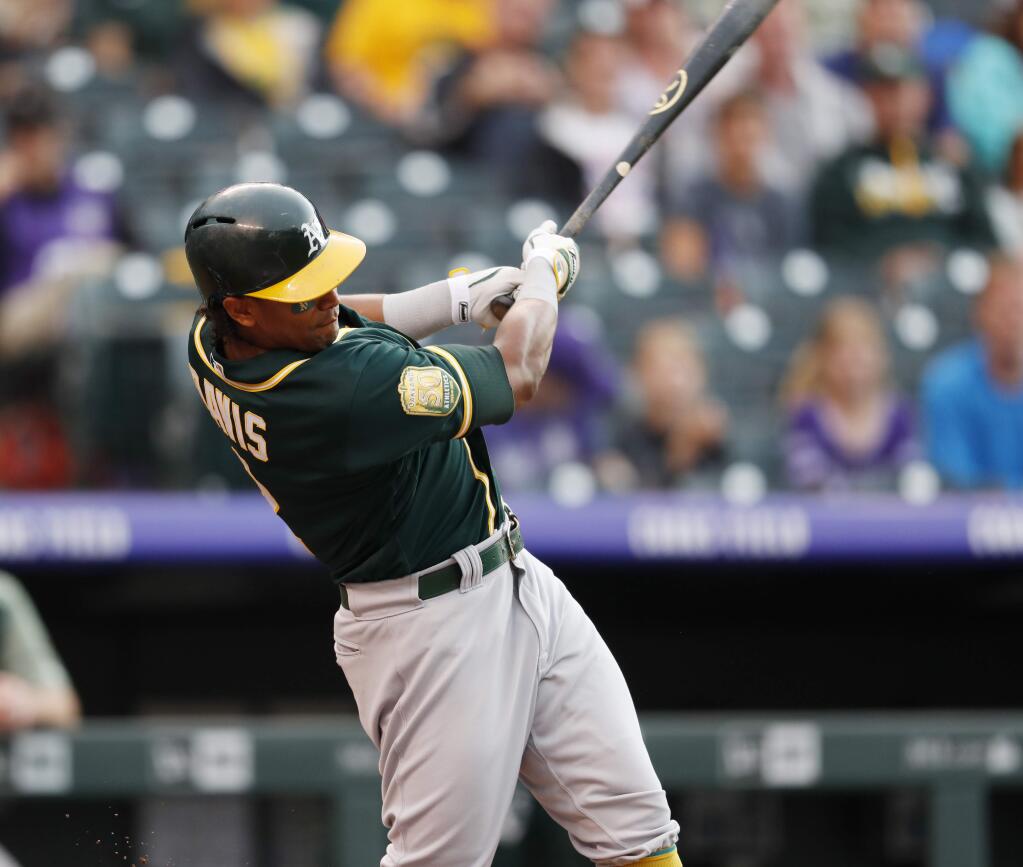 Oakland Athletics' Khris Davis singles off Colorado Rockies starting pitcher Kyle Freeland in the first inning of a baseball game Friday, July 27, 2018, in Denver. (AP Photo/David Zalubowski)