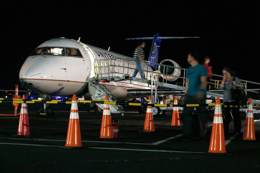 Passengers disembark from United Airlines Flight 5709 from San Francisco at Charles M. Schulz–Sonoma County Airport, in Santa Rosa, California, on Wednesday, October 10, 2018. (Alvin Jornada / The Press Democrat)
