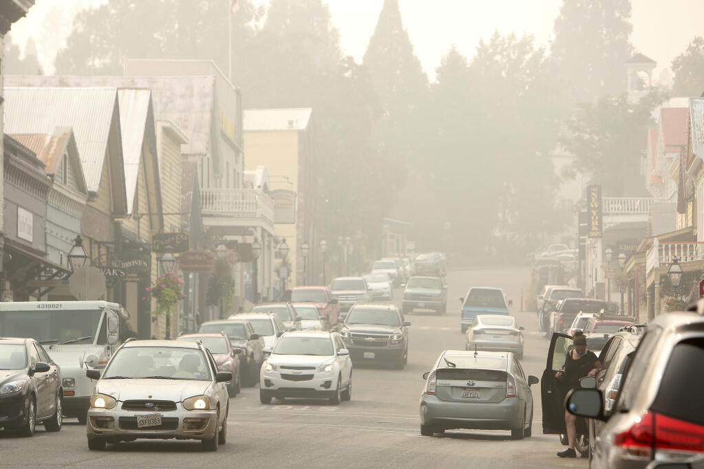 Air quality has deteriorated to unhealthy levels across many Northern California communities due to increased smoke from the many wildfires burning across the region, Saturday, Sept. 12, 2020. That hasn't kept folks from venturing into downtown Nevada City or Grass Valley to shop and eat at restaurants. Saturday's aqi read unhealthy at 365 pm2.5 in Western Nevada County. (Elias Funez/The Union via AP)