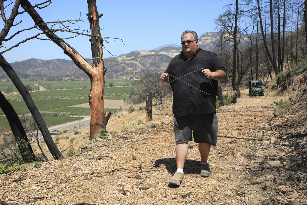 Rob Thompson dowsing for water at a Napa Valley vineyard in Calistoga, Calif., July 13, 2021. Amid California’s drought, desperate landowners and managers are turning to those who practice an ancient, disputed method for locating water. (Jim Wilson/The New York Times)