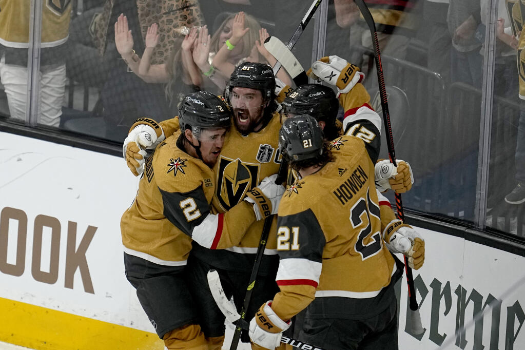 Vegas Golden Knights right wing Mark Stone, left, celebrates his goal against the Florida Panthers with Brett Howden (21), defenseman Zach Whitecloud (2) and center Chandler Stephenson during the third period of Game 1 of the Stanley Cup Final, Saturday, June 3, 2023, in Las Vegas. (Abbie Parr / ASSOCIATED PRESS)