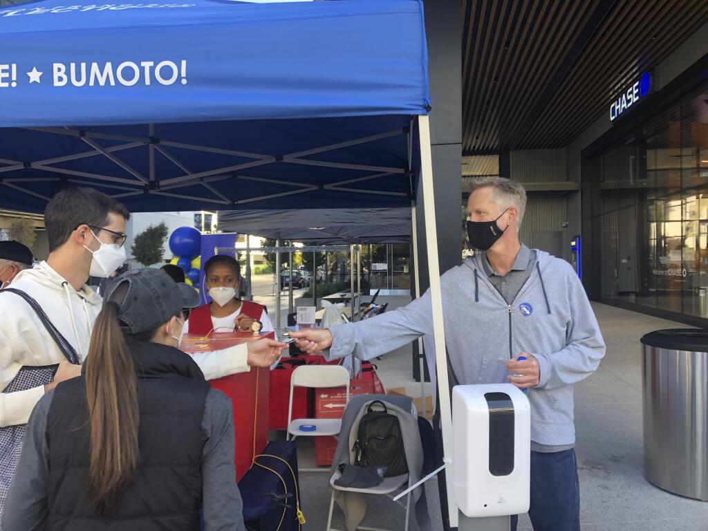 Golden State Warriors coach Steve Kerr hands out “I Voted” stickers at a ballot drop-off station at Chase Center in San Francisco on Saturday, Oct. 31, 2020. (Janie McCauley / ASSOCIATED PRESS)