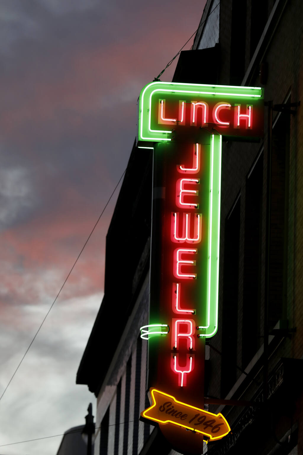 The newly restored Linch Jewelry sign now burns brightly in downtown Petaluma. (Beth Schlanker/The Press Democrat)