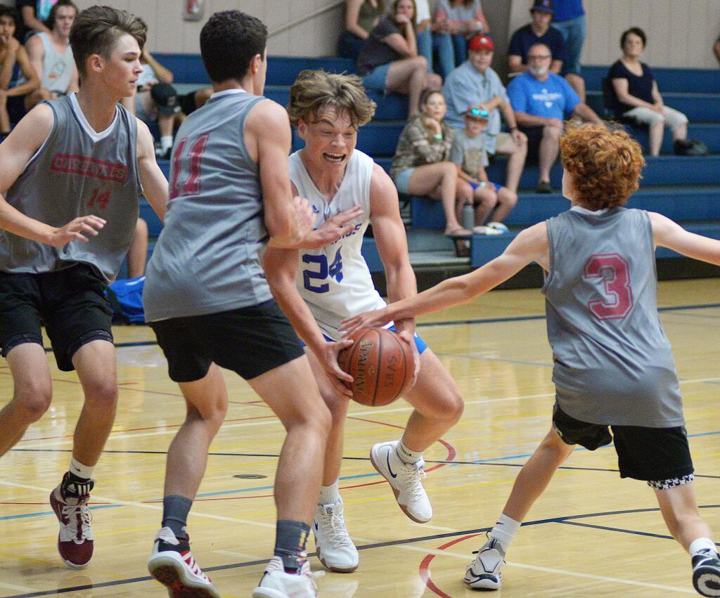 St. Vincent’s Killian Collins (24) tries to battle through three defenders in the Mustangs’ 42-28 win over Averroes in the Mustang Summer Jam. (SUMNER FOWLER / FOR THE ARGUS-COURIER)