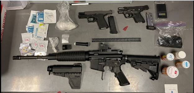 This image shows guns and drugs confiscated by Santa Rosa police Sunday, Aug. 14, 2022. They were looking for a suspect on Carson Street when they arrested a second suspect who had the weapons and drugs. (Santa Rosa Police Department)