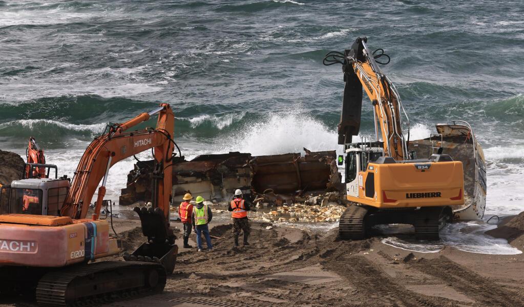 Personnel from Parker Diving of Sausalito salvage what is left from the Aleutian Storm fishing vessel on Salmon Creek State Beach south, Wednesday, March 6, 2024, north of Bodega Bay. (Kent Porter / The Press Democrat file)