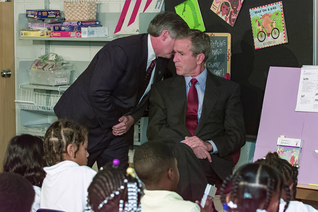In this Tuesday, Sept. 11, 2001 file photo, White House chief of staff Andrew Card whispers into the ear of President George W. Bush to give him word of the plane crashes into the World Trade Center, during a visit to the Emma E. Booker Elementary School in Sarasota, Fla. (AP Photo/Doug Mills, File)