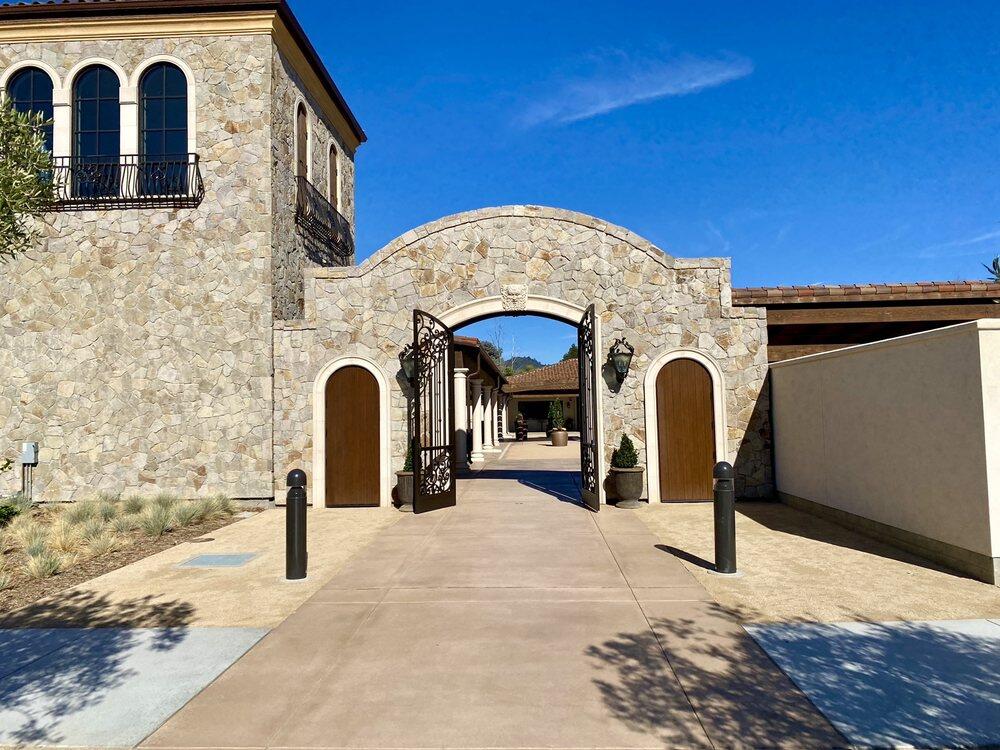 A stone arch entrance gate to the Mediterranean-style Bacchus Landing’s new hospitality center invites guests to enter a piazza with olive trees leading to five unique tasting rooms, café and event space along with a bocce court and lawn game area within this 3-acre compound.