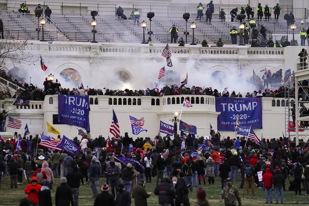 FILE - People loyal to President Donald Trump storm the U.S. Capitol on Jan. 6, 2021, in Washington. Federal authorities say a Southern California man who assaulted police with pepper spray during the storming of the U.S. Capitol was sentenced to 4 1/2 years in prison. The U.S. Department of Justice said in a statement Friday, April 28, 2023, that Jeffrey Scott Brown of Santa Ana, Calif., received a sentence of 54 months. (AP Photo/John Minchillo, File)