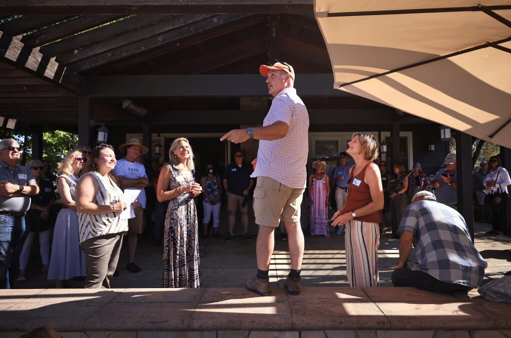 Mark Farmer, greets fellow Walbridge fire survivors, Saturday, July 17, 2021 at the residence of the Groom family, nearly a year after the fire tore through mountain canyon enclave, destroying dozens of homes west of Healdsburg.   (Kent Porter / The Press Democrat) 2021