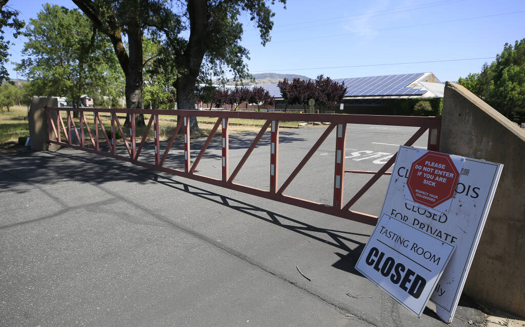 The main gate in to Clos du Bois is locked, Saturday, May 8, 2021, in Geyserville, after the company laid off nearly all of their 37 employees. (Kent Porter / The Press Democrat)