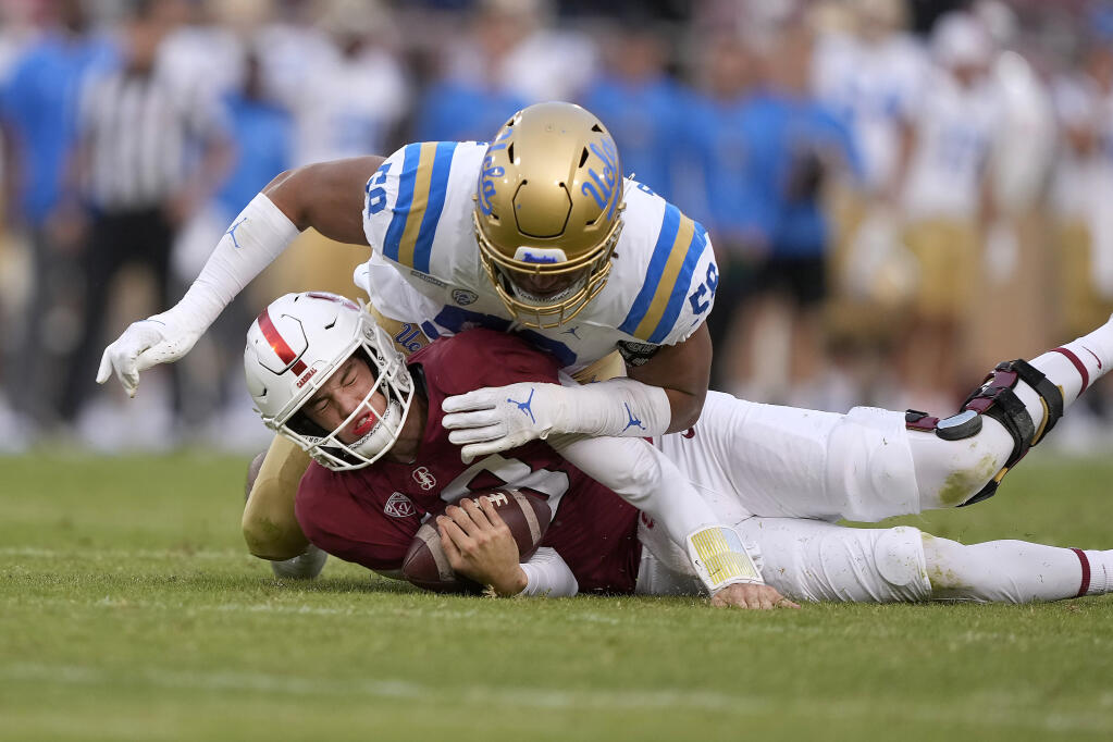 Stanford quarterback Tanner McKee is sacked by UCLA linebacker Kobey Fitzgerald during the second half on Saturday, Sept. 25, 2021, in Stanford. UCLA won 35-24. (Tony Avelar / ASSOCIATED PRESS)