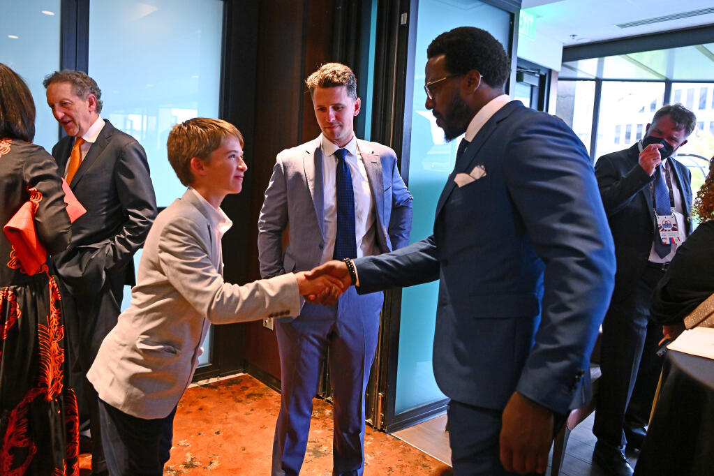 Lee Posey, 11, left, shakes hands with Patrick Willis while standing with his father, Buster Posey, during media interviews before the Bay Area Sports Hall of Fame ceremony at the Hyatt Regency in San Francisco on Thursday, May 25, 2023. The Bay Area Sports Hall of Fame Class of 2023 includes Julie Foudy, Gary Payton, Andre Ward, Posey and Willis. (Jose Carlos Fajardo / San Jose Mercury News)