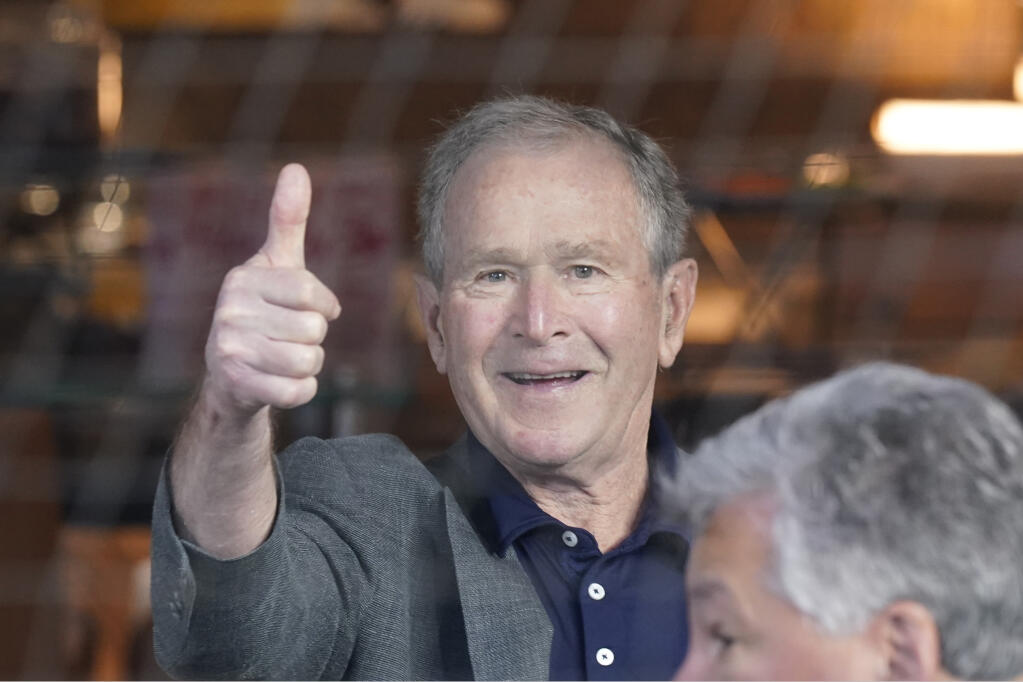 Former President George W. Bush gives a thumbs-up before a baseball game between the Atlanta Braves and the Texas Rangers in Arlington, Texas, Sunday, May 1, 2022. (AP Photo/LM Otero)