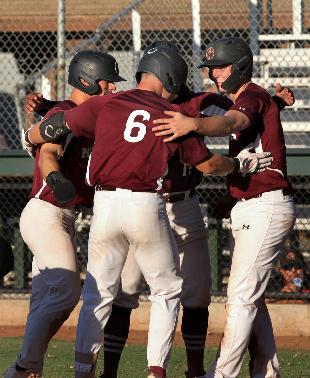 The Healdsburg Prune Packers’ Joey Kramer, center, celebrates with teammates after hitting a grand slam in the third inning against the Walnut Creek Crawdads on Tuesday, Aug. 2, 2022, in Healdsburg. (Darryl Bush / For The Press Democrat)