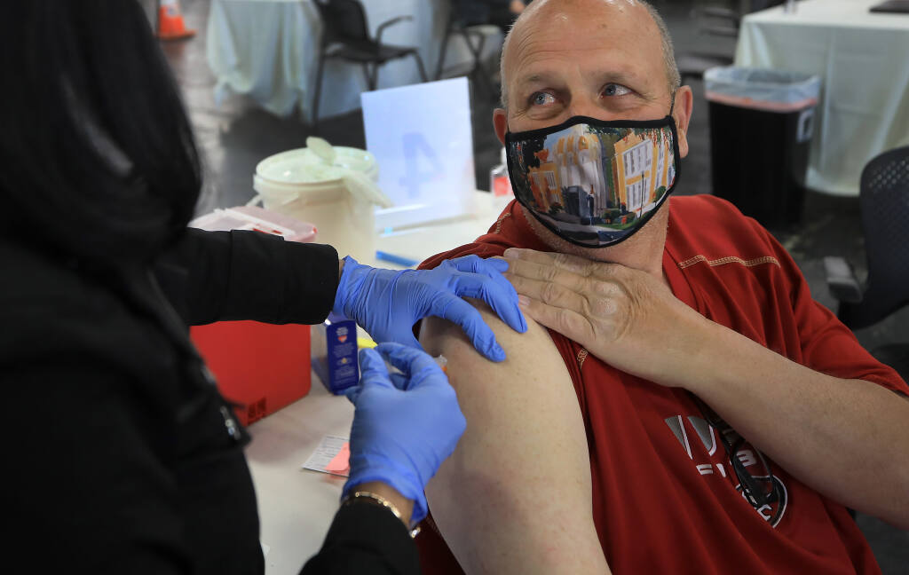 Todd Beseda of Santa Rosa  receives his second Moderna vaccine shot during the Sonoma County Medical Association's vaccine clinic at the Sonoma County Fairgrounds, Thursday, March 4, 2021 in Santa Rosa. (Kent Porter / The Press Democrat) 2021