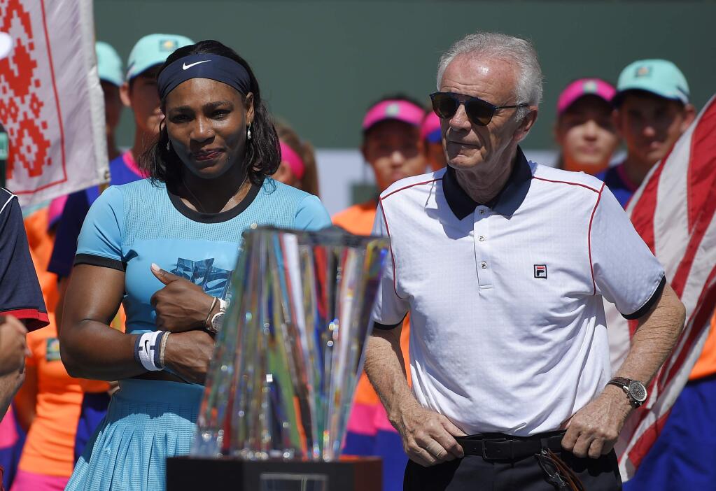 Serena Williams stands with tournament director Raymond Moore after Victoria Azarenka, defeated Williams in a final at the BNP Paribas Open tennis tournament, Sunday, March 20, 2016, in Indian Wells, Calif. Azarenka won 6-4, 6-4. (AP Photo/Mark J. Terrill)