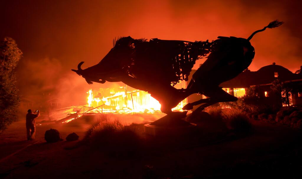 Soda Rock Winery burns as the Kincade fire jumps Highway 128 in the Alexander Valley on Sunday, Oct. 27, 2019. (Kent Porter / The Press Democrat)