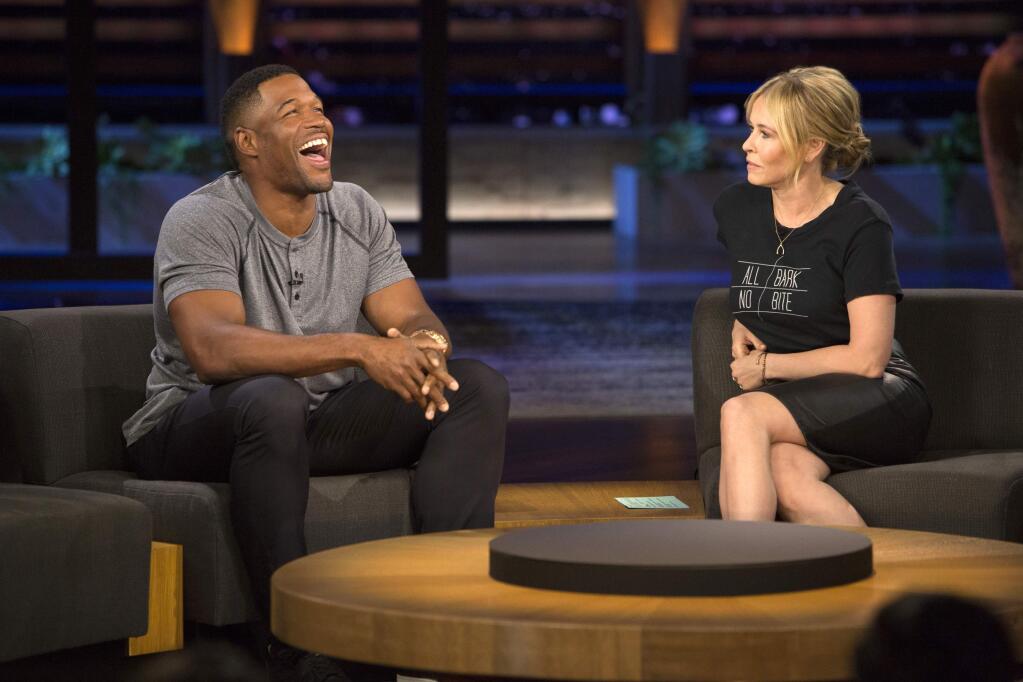 This June 22, 2016 photo released by Netflix shows host Chelsea Handler, right with guest Michael Strahan on her talk show, 'Chelsea,' in Los Angeles. (Photo by Greg Gayne/Netflix)