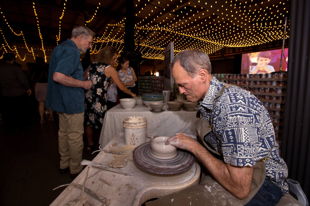 Chris Landwehr, demonstrating ceramic artist, makes bowls during the Empty Bowls dinner and auction, Saturday, April 22, 2023, at Redwood Empire Food Bank in Santa Rosa. (Darryl Bush / For The Press Democrat)