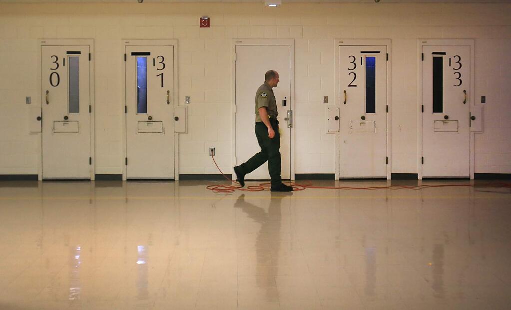 Kent Porter / The Press DemocratMAKING THE ROUNDS: A Sonoma County sheriff corrections officer checks jail cells in the mental health wing at the Sonoma County Main Adult Detention Facility in Santa Rosa in November. In 2016, the Sonoma County Jail held an average of 429 inmates daily with mental illness, ranging from mild depression to severe schizophrenia, up from 228 in 2008.