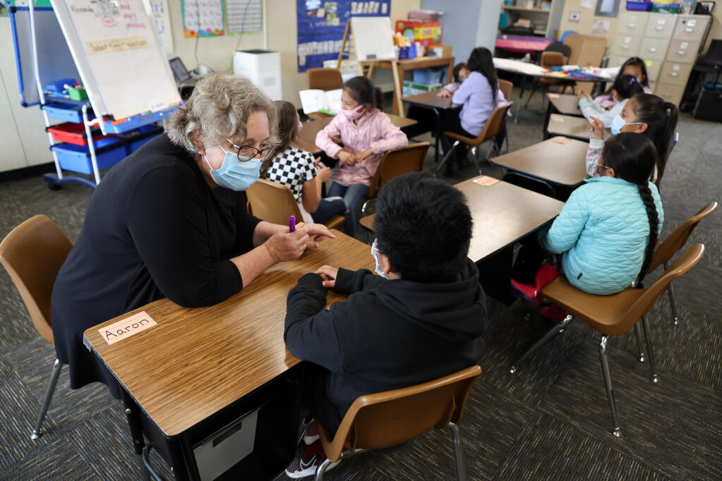 Teacher Elizabeth Olah works with a student during an English language development class at Mattie Washburn Elementary School in Windsor, Tuesday, Nov. 2, 2021. (Christopher Chung/The Press Democrat file)