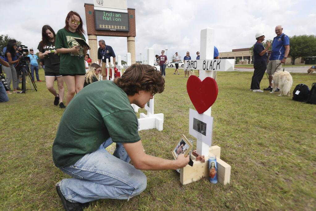 Santa Fe High School students, parents and the community observed a Moment of Silence Monday, May 21, 2018, in Santa Fe. Texas Governor Greg Abbott has called for a moment of silence at 10 a.m. Monday morning to remember the victims of the Santa Fe School Shooting. (Steve Gonzales/Houston Chronicle via AP)